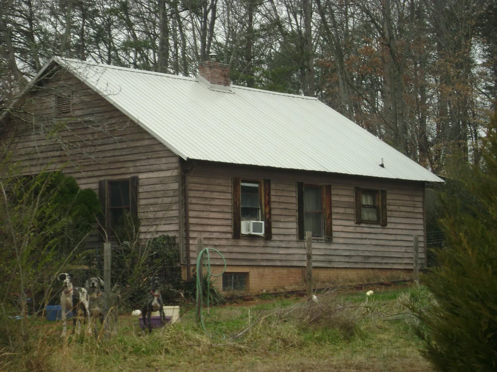 White metal roof on an old wood sided farmhouse, from a Metal Roof Installation job in Woonsocket